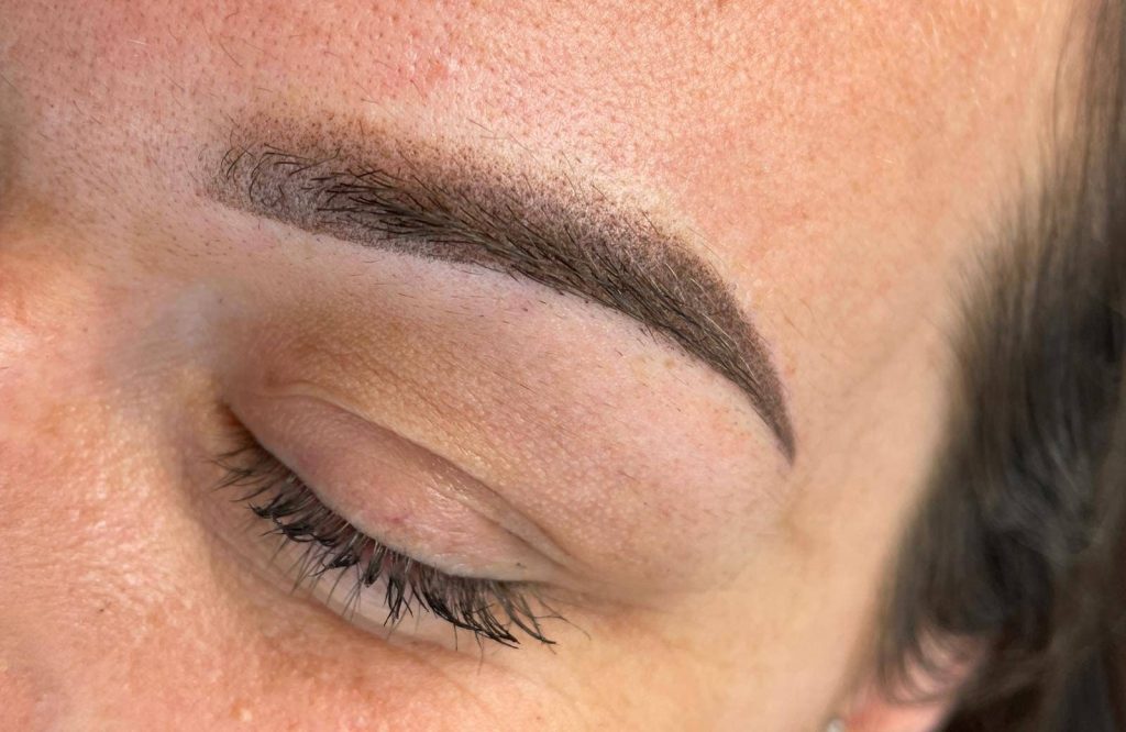 Finished permanent eyebrow results enhancing overall brow shape.