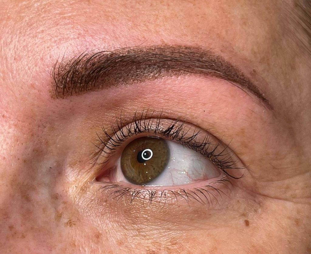 Close-up of permanent eyebrows showing detailed cosmetic work.